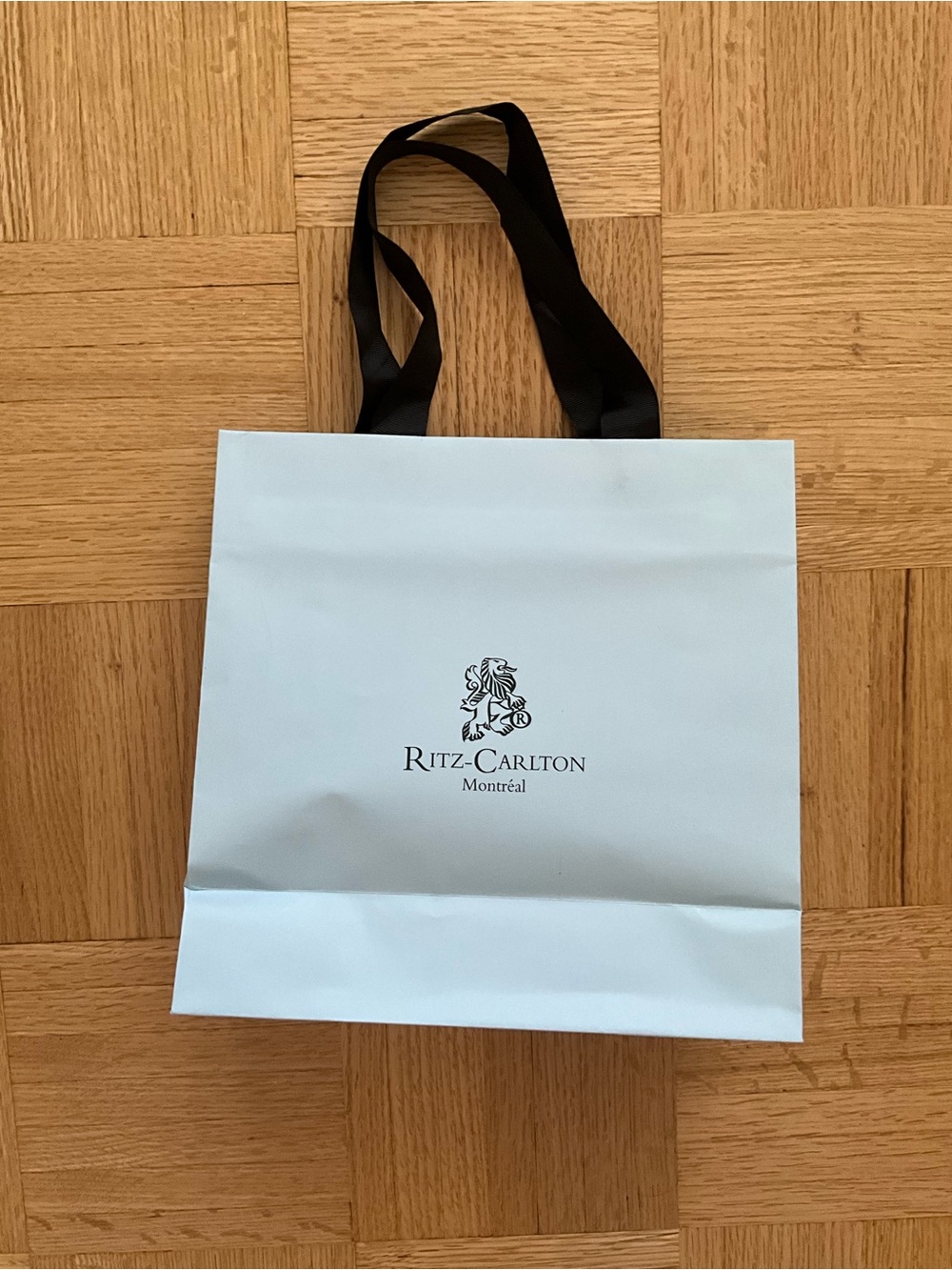 Elegant The Ritz Montreal Light Blue Tote Bag with Black Handles